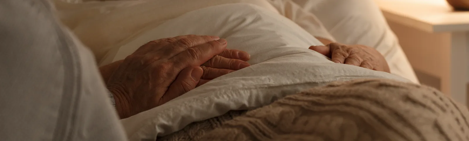 A comforting hand reaching out in a softly lit bedroom, a quiet gesture of grounding