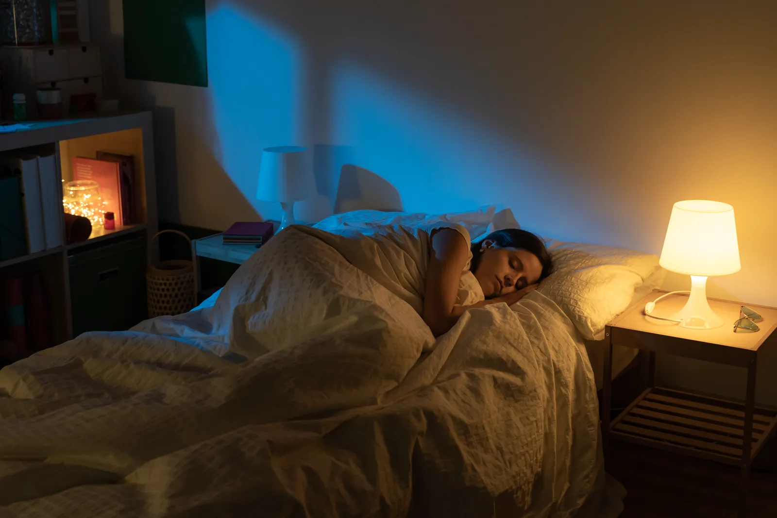 A woman sleeping peacefully on her side in soft natural morning light