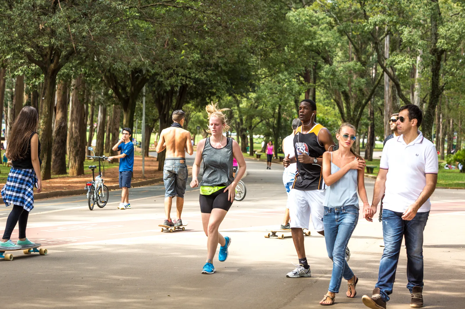 People enjoying a public space, some reading, some walking, some sitting