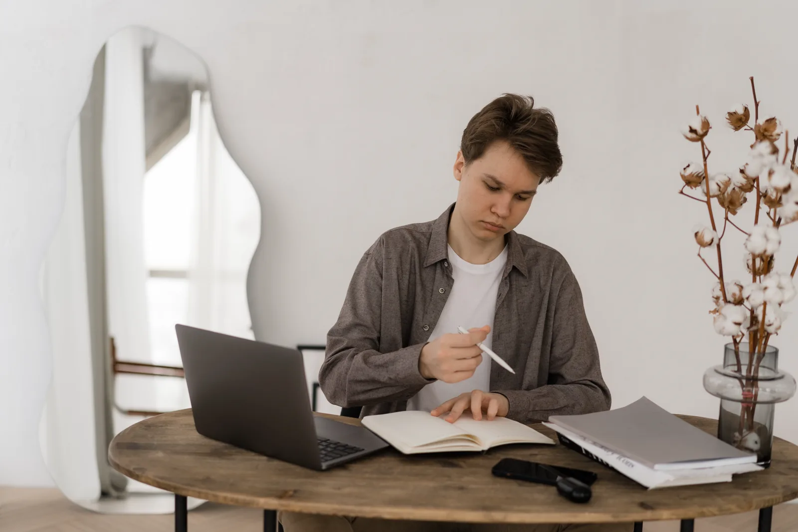 A person working with calm concentration at an uncluttered desk in soft natural light