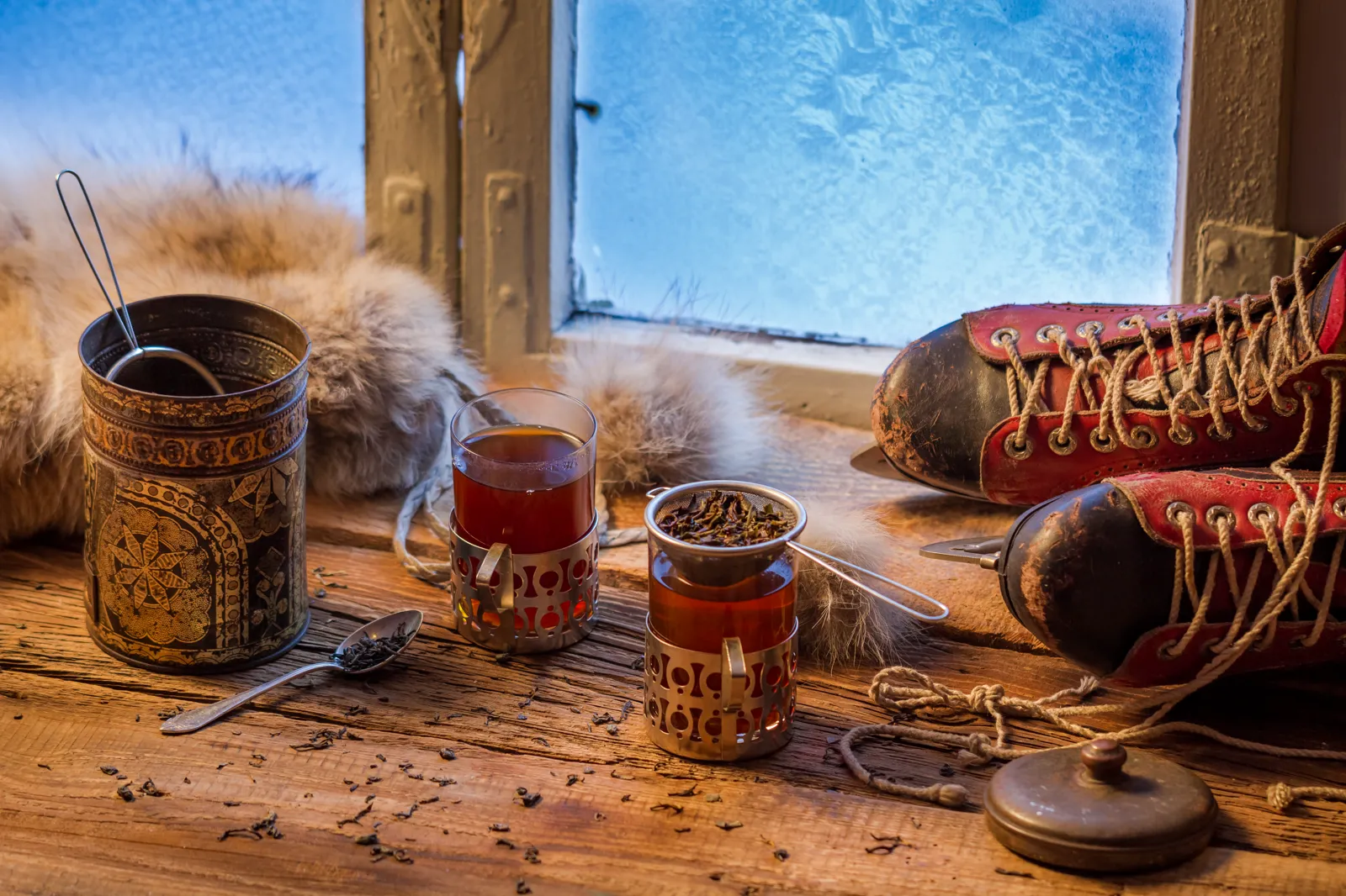 Vintage-style tea time with old ice skates on the table, warm light