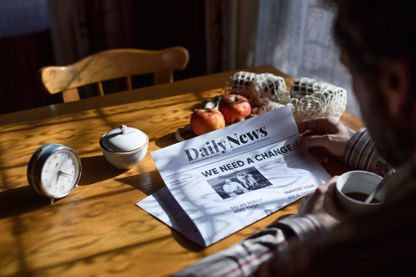 A person reading the day's news calmly over a cup of coffee at a table